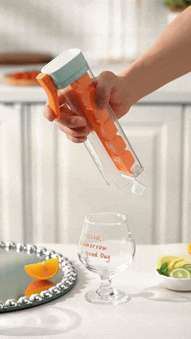Squeezing the handle to release ice cubes into a glass
